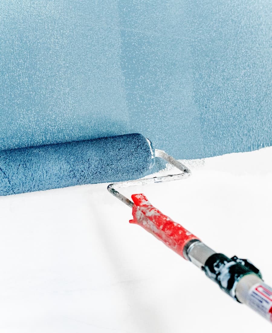 Fresh paint roller on a newly painted wall
